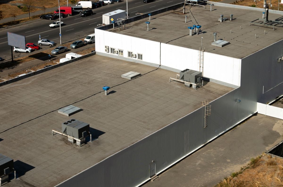 View of the roof of a commercial building in the middle of the city